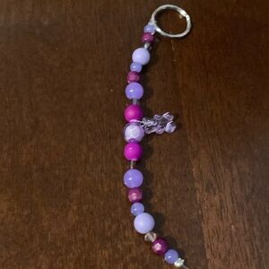 A purple beaded gummy bear keychain